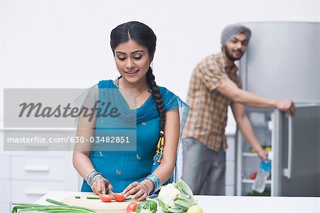 Woman chopping vegetables in the kitchen
