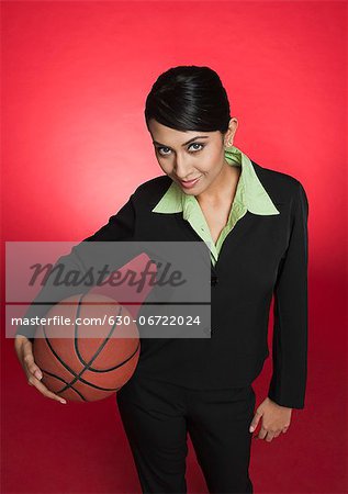 Portrait of a businesswoman holding a basketball