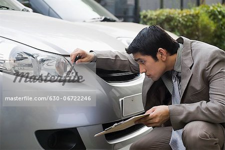 Insurance adjuster inspecting a car