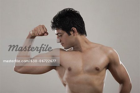 Bodybuilder Showing His Toned Biceps Stock Photo by