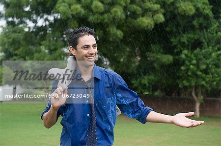 Businessman enjoying rain