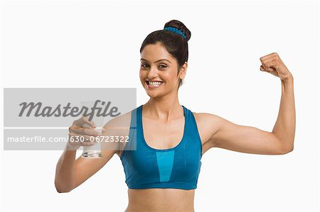 Woman flexing her biceps, Stock Photo, Picture And Royalty Free