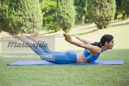 Woman doing Dhanurasana (Bow Pose)