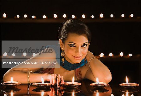 Woman decorating oil lamps in Diwali festival
