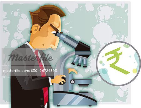 Businessman examining rupee symbol through a microscope