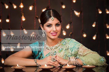 Woman with oil lamps on Diwali