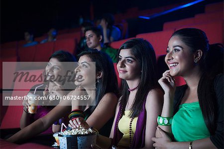 Youngsters enjoying movie in a cinema hall