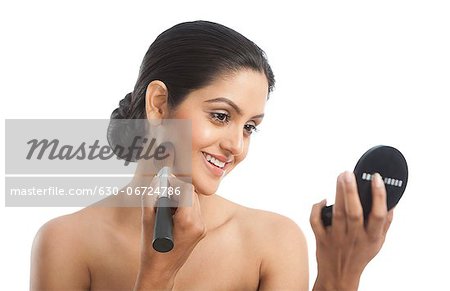 Woman applying make up