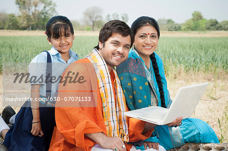 Farmer family using a laptop, Sohna, Haryana, India