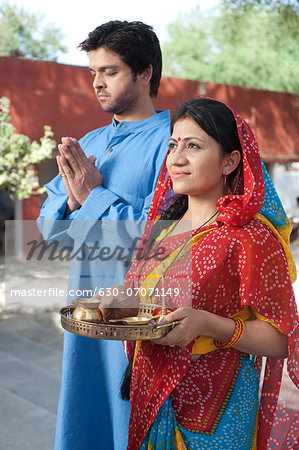 Rural couple praying, Sohna, Haryana, India