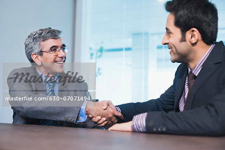 Businessman shaking hands with another businessman