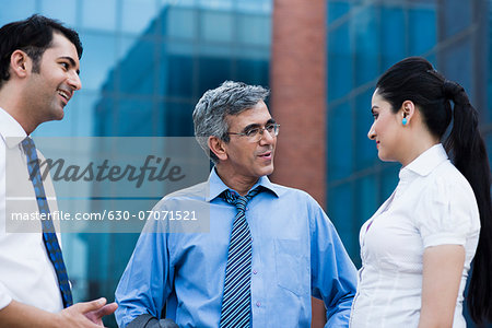 Business executives discussing outside an office building