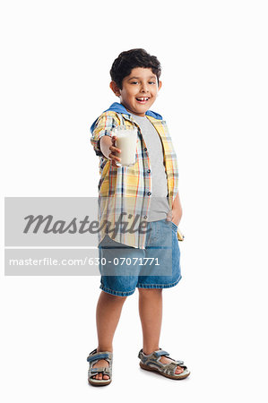 Boy holding a glass of milk
