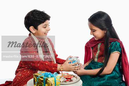 Cute doodle of a brother giving gift to his sister on occasion of Raksha  Bandhan festival. - Stock Image - Everypixel