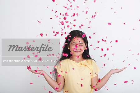 Rose petals falling on a girl