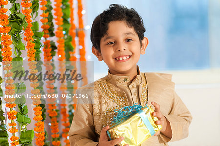 Boy holding a gift on Diwali