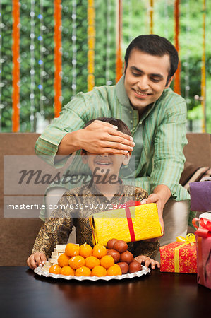 Man giving gift to his son on Diwali