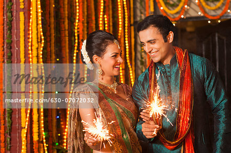 Happy Diwali Day! Lovely Indian Couple In Love, Wear At Saree And Elegant  Suit, Posed On Restaurant And Hold Lantern Together. Stock Photo, Picture  and Royalty Free Image. Image 119276598.