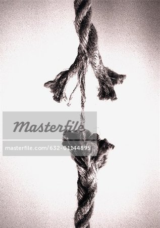 Frayed rope about to break - Stock Photo - Masterfile - Premium