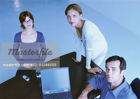 Business people around desk, smiling, elevated view