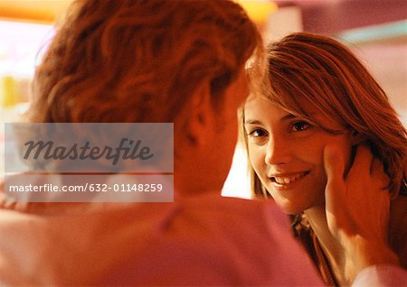 Woman caressing a mans hair  CanStock