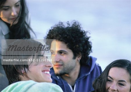 Young people sitting together, close-up