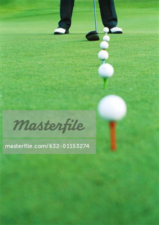 Golfer on driving range, low section