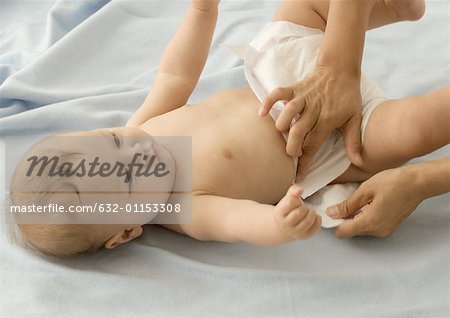 Baby having diaper changed