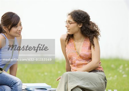 Two teen girls standing in school gym - Stock Photo - Masterfile