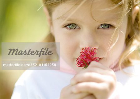 Girl smelling flower