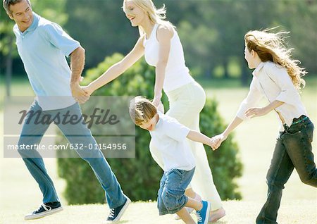 Family holding hands and running