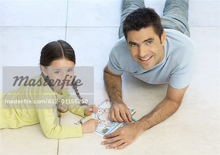 Father and daughter putting together puzzle together