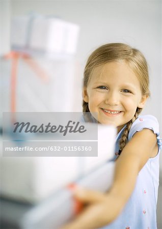 Girl holding stack of presents