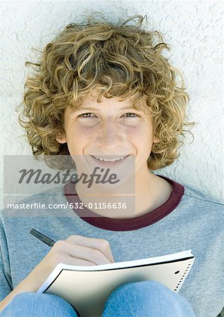 Preteen boy writing, portrait