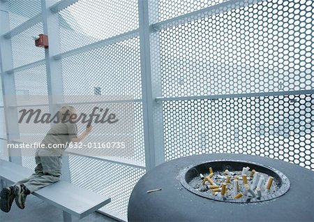 Child looking through walls made of metal grating