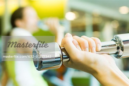 Woman's hand holding dumbbell, close-up