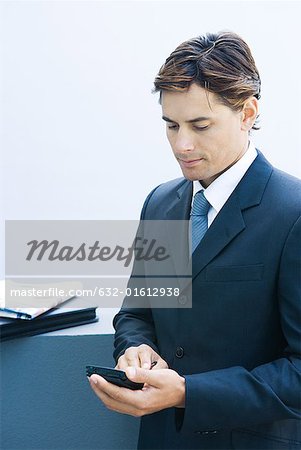 Businessman using electronic organizer