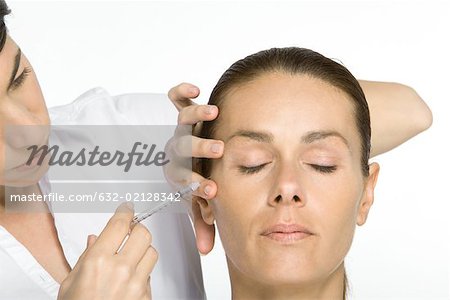 Woman receiving Botox injection, eyes closed