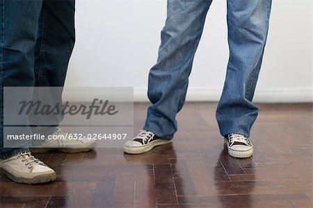Men wearing jeans, sneakers, low section