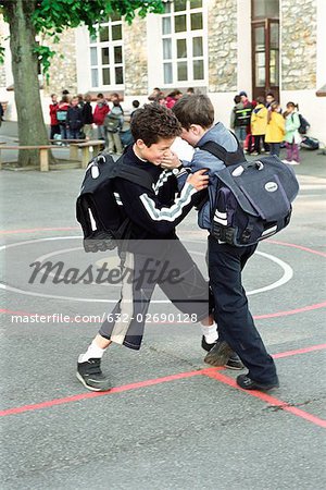 Boys fighting on school playground