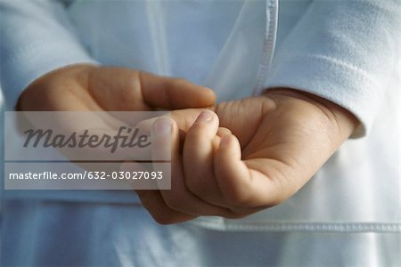 Child with hands clasped behind back, close-up