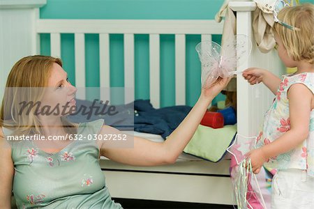 Woman playing with daughter in nursery