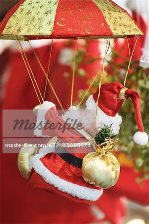 Christmas decoration featuring Santa Claus hanging from parachute