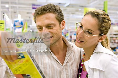 Couple looking at DVD together in store