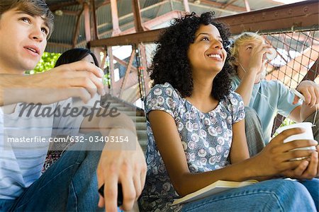 Young woman hanging out with friends watching sports event