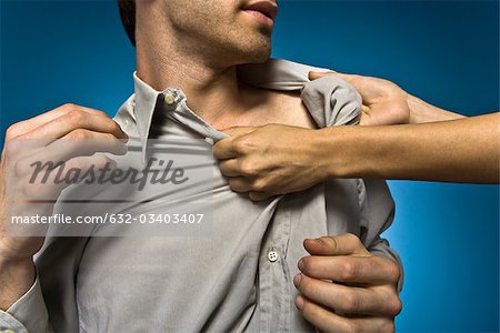 Woman grabbing man by shirt collar