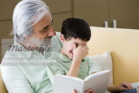 Senior man reading story to grandson