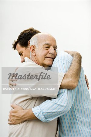Senior man embracing adult son