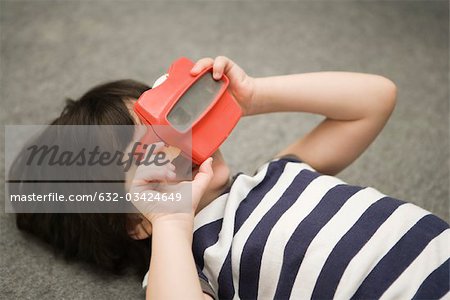 Child looking through toy viewfinder