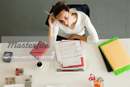 Businesswoman daydreaming at desk